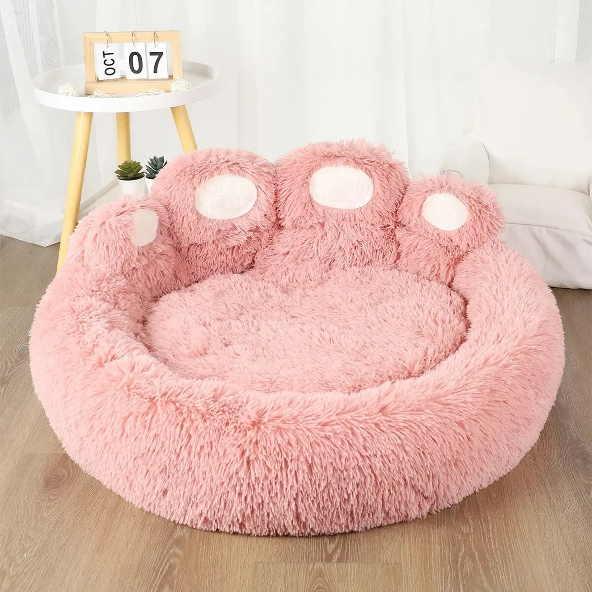 Lit apaisant en forme de patte pour chien rose 